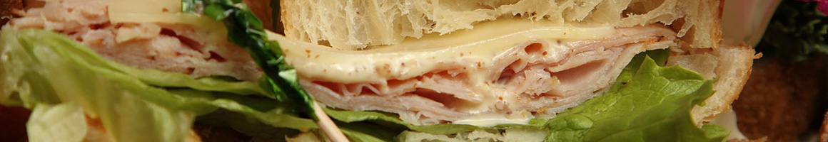 Eating Sandwich Cafe at Rising Roll Gourmet Cafe' restaurant in Lawrenceville, GA.